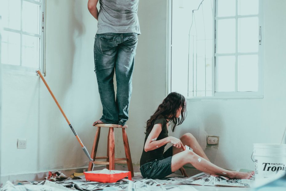 couple painting a house